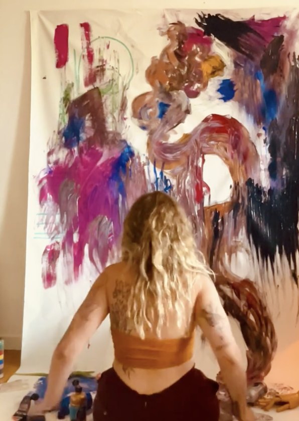 Eden King at work on a large God's Armor canvas in the studio